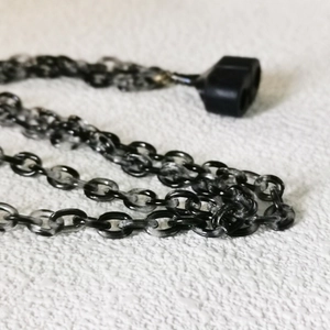 Macro shot of acrylic anti-loss chain with black and white gradient oval plastic links