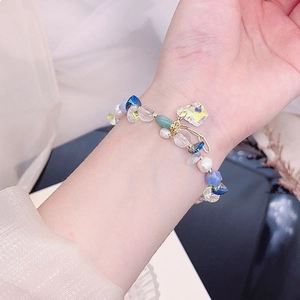 Close-up of adjustable bead bracelet featuring pearls, blue crystals and star charm