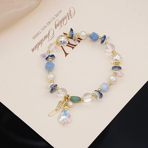 Detail of beaded bracelet with blue crystals, pearls and iridescent teardrop pendant