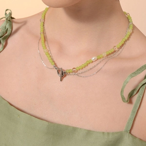 Garden style grape crystal and pearl necklace with silver OT clasp on a green background