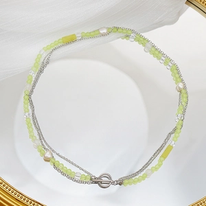 Multi-layer necklace with green beads, pearls and silver chains featuring a stylish OT clasp