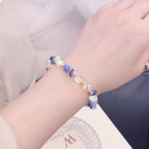 Detailed shot of an adjustable beaded bracelet with blue quartz and freshwater pearls