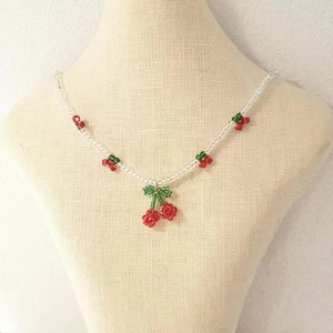 Collier de perles fait main avec cerises en cristal rouge sur une chaîne de perles blanches