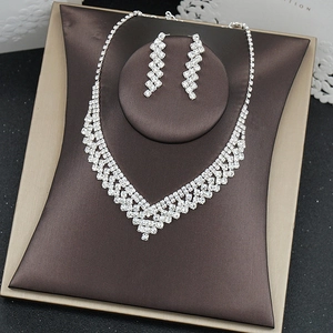 Macro detail of silver necklace and earring set with shimmering pavé crystal inlay