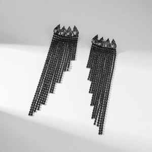 Detail of long black rhinestone tassel earrings with water-drop crystals on gray background