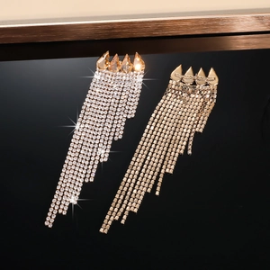 Detail of luxury gold rhinestone tassel earrings showing front and back views with sparkles