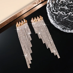 Macro shot of long champagne rhinestone fringe earrings with crystal tassel detail