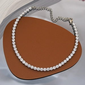 Détail d'un collier tennis argenté avec zircons de 5mm sur un support en cuir