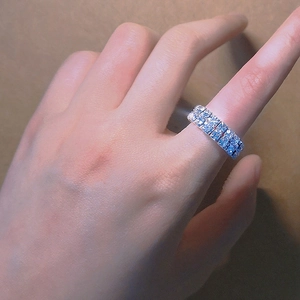 Detail showing double-row sparkling crystal pave setting on elastic silver ring band