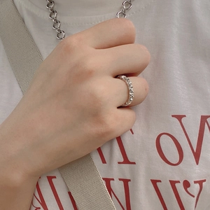 Detailed view of silver eternity ring with sparkling rhinestones on model finger