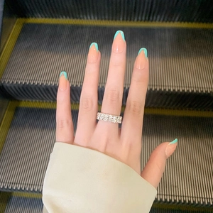 Detail of silver double-row rhinestone ring with sparkling crystals on a finger