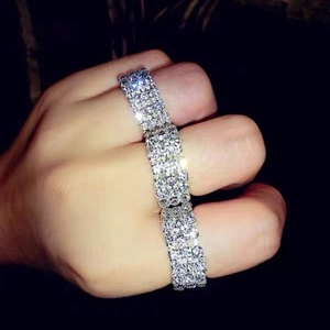 Detailed view of three-row silver stretch rings fully set with sparkling rhinestones