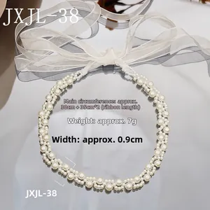 Macro shot of pearl beaded necklace with organza ribbon detailing and product dimensions