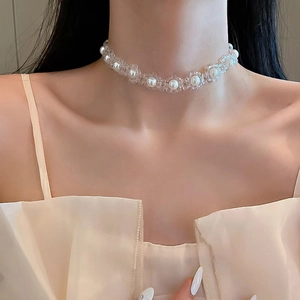 Close-up of pearl and flower beaded choker necklace worn on model neck for elegant styling