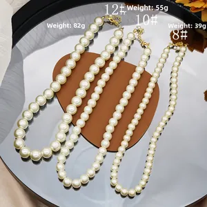Detail of assorted glass pearl necklaces in 8mm 10mm 12mm sizes on a mirror display