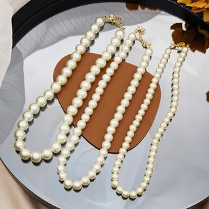 French minimalist glass pearl necklace set in four different bead sizes with gold clasps