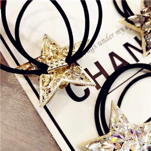 Close-up of sparkling star-shaped crystal hair ties with elastic bands on display card
