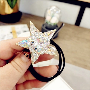 Detail of crystal star hair tie with sparkling rhinestones and black elastic band