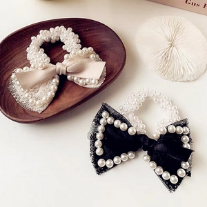 Elegant pearl bow hair scrunchies in cream and black featuring lace and satin details