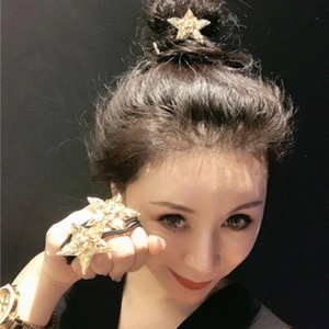 Detail of sparkling crystal star hair tie and clip set worn on a messy bun hairstyle