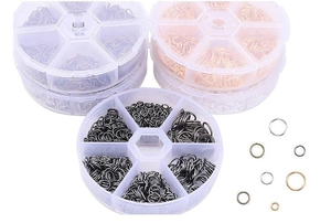 Close-up of mixed sizes and colors open jump rings in transparent six-grid storage boxes