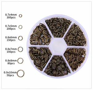 Detail view of 4-10mm antique bronze open jump rings set in a 6-grid organizer box