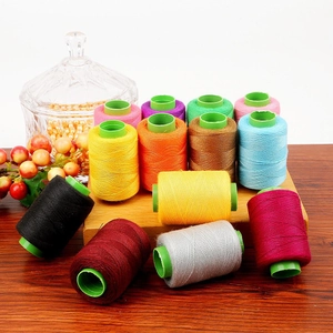 Colorful polyester sewing thread set on wooden base for DIY hand and machine stitching