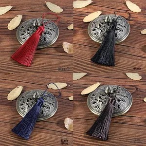 Detail of 8cm silk tassels in wine red, black, dark blue and coffee on bronze lid