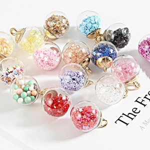Close-up of star sequins and colorful beads inside crystal glass ball charms for DIY