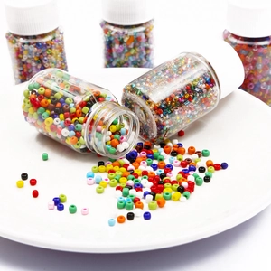 Colorful DIY glass seed beads in transparent bottles for handmade jewelry making and crafts