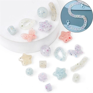 Macro shot of colorful glitter resin beads in star and butterfly shapes for DIY jewelry