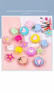 Macro detail of colorful acrylic star and heart charms for DIY jewelry and crafts