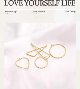 Macro detail of 14K gold plated geometric pendants on white silk for jewelry making