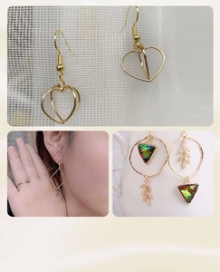 Detail of 14K gold plated geometric earrings featuring heart shapes and colorful leaf charms