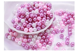 Mix of colorful round ABS pearl beads with center holes on white silk for DIY jewelry