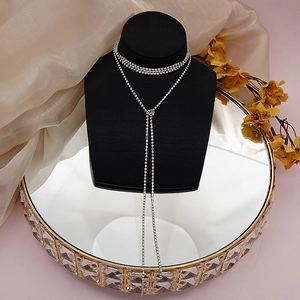 Macro detail of silver layered rhinestone choker and long tassel Y-shaped necklace set