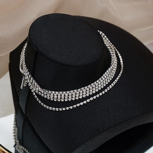 Macro detail of elegant multi-layer silver choker with sparkling rhinestones on black stand
