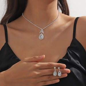 Sparkling silver necklace and pear-cut zircon earrings jewelry set on a female model