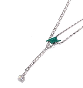 Detail of silver necklace with green knotted thread and square zircon pendant