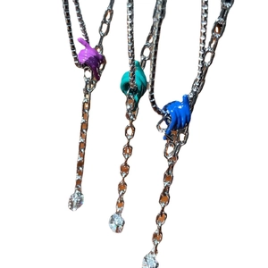 Three chunky silver necklaces with colorful Shaka hand pendants and crystal accents