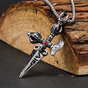 Close-up of retro punk sword cross pendant in titanium steel with a red zircon inlay