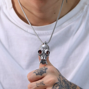 Detail shot of vintage punk wolf skull pendant on a box chain with antique silver finish