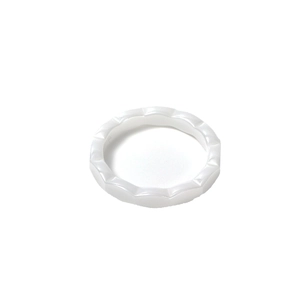 Minimalist white ceramic ring featuring a unique continuous wave faceted geometric design