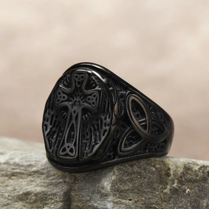Detail of matte black stainless steel signet ring with embossed Celtic cross on stone