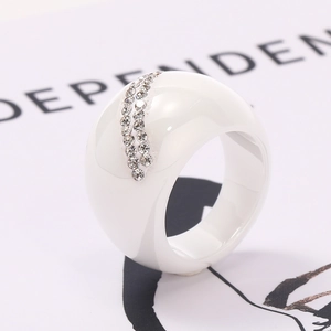 Macro side view of thick white ceramic dome ring with sparkling double-row rhinestones