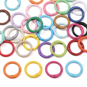 Close-up of colorful spring snap hooks in various painted alloy finishes for DIY keychains