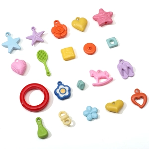 Close-up of colorful acrylic charms in various shapes like stars and flowers for DIY jewelry