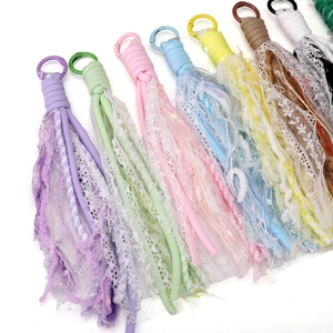 Detailed view of colorful lace tassel pendants with woven cords for DIY jewelry making