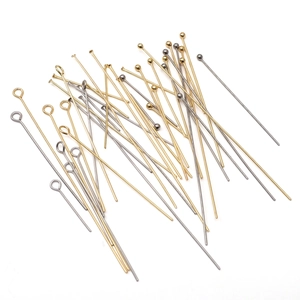 Close-up of gold and silver stainless steel eye, ball and flat head pins for DIY jewelry