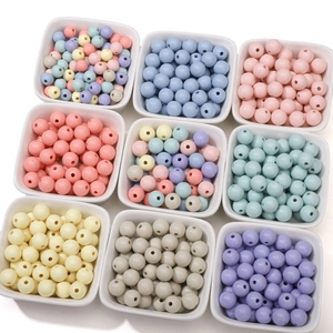 Macro detail of 8-10mm acrylic cream beads in colorful matte finish for DIY jewelry
